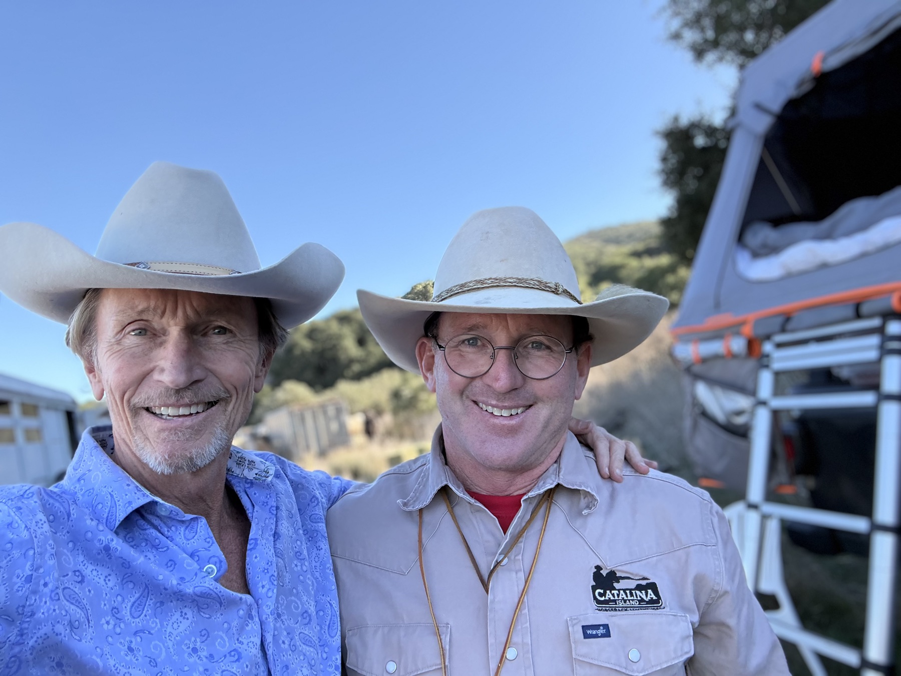 Mike and William in cowboy hats at the ranch
